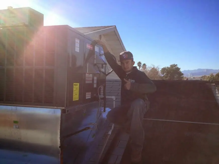 HVAC technician performing Boiler Repair on a rooftop unit in Eden Prairie